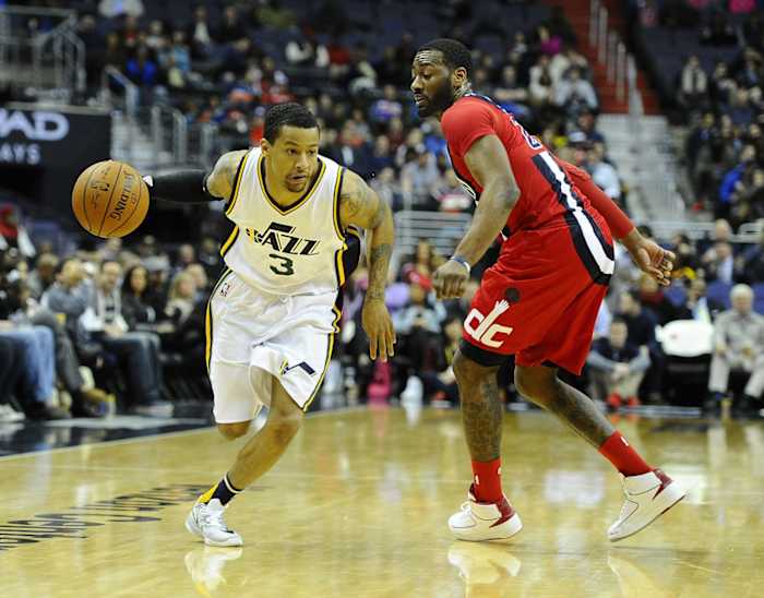 Utah Jazz guard Trey Burke (3) dribbles past Washington Wizards guard John Wall (2) during the second half at Verizon Center. The Washington Wizards won 103-89.